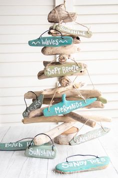 a christmas tree made out of driftwood and signs