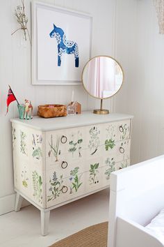 an image of a white dresser with flowers on it and a mirror over the top