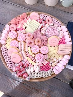 a platter filled with lots of pink and white treats