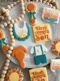 baby shower cookies are arranged on a plate