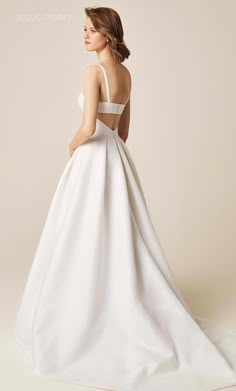 a woman in a white wedding dress is looking back