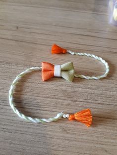 an orange and white bow tie on a wooden table