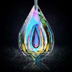 a multicolored glass hanging ornament on a black background