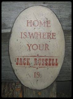 a sign that says home is where your jack russell is