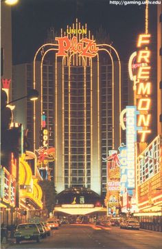 the las vegas hotel and casino is lit up at night with cars driving down the street