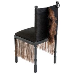 a black and brown chair with a furry tail on it's back