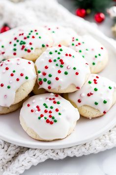 cookies with white icing and sprinkles on a plate