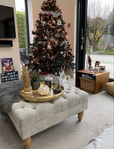 a living room with a christmas tree in the corner