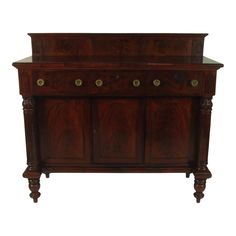 an old wooden cabinet with brass knobs on the top and bottom drawers, against a white background