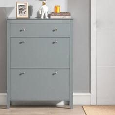 a grey chest of drawers in a room