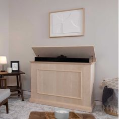 a living room with a couch and a record player on top of a wooden cabinet