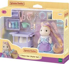 the toy playset is in its box and has toys like hairbrushes, combs, and other accessories