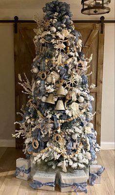 a blue and white christmas tree with bells