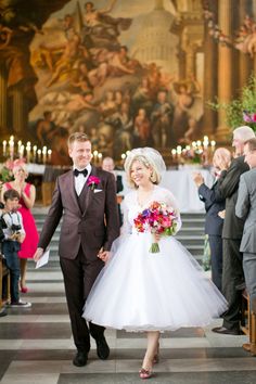 the bride and groom are walking down the aisle