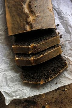 slices of chocolate cake sitting on top of wax paper