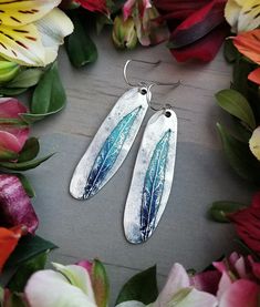 "These simple, elegant earrings have a rustic feel that's perfect for everyday wear, but just enough color and shine to dress up for a special occasion! They feature an antiqued, organic, oval charm plated in either 24kt gold or sterling silver with a textured willow leaf design. The leaf is hand-painted with a turquoise to iris blue ombre. The earrings measure approximately 2.125\" long x .5\" wide and the earwires are hypo-allergenic, 10kt gold-filled or sterling silver. ** Please note: these Rustic Turquoise Earrings For Gift, Nature-inspired Blue Dangle Earrings, Blue Teardrop Earrings With Patina, Rustic Turquoise Nickel Free Earrings, Rustic Turquoise Nickel-free Earrings, Blue Nature-inspired Drop Earrings, Unique Blue Earrings For Everyday, Unique Blue Everyday Earrings, Hand Painted Turquoise Drop Earrings