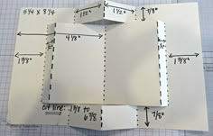 three pieces of paper cut into squares on top of a cutting mat with measurements for each piece