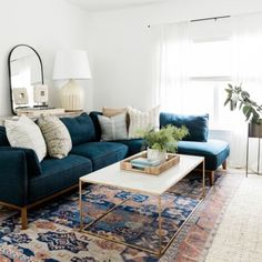 a living room with blue couches and rugs