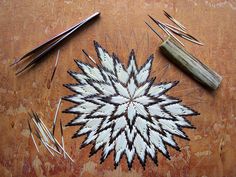 a wooden table topped with lots of different types of scissors and needles on top of it