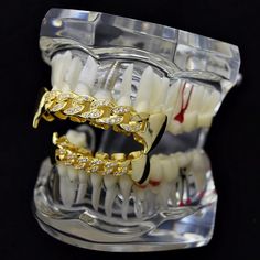 PRE-MADE GRILLZ Best Grillz™ CZ cuban fang grillz set. Grillz are 14k gold plated over brass metal. Hip hop grillz encrusted with real CZ stones. Cuban fangs design - 6 top, 6 lower teeth. Two silicone molding bars and instructions. FDA approved (21 CFR 175,300) silicone. Nickel and lead-free, safe to wear in mouth. Quick and easy to fit in about five minutes. Grillz are designed to fit most adult teeth. Real looking gold grillz made in Korea. 100% FREE SHIPPING in USA. Order now!Quick & Eas Gold Iced Cuban Link Jewelry, Iced Gold Cuban Link Jewelry, Fangs Grillz, Gold Fangs, Fang Grillz, Gold Grillz, Mold Kit, Hip Hop Jewelry, Fda Approved