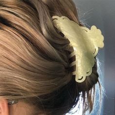 a close up of a woman's hair with an animal shaped comb in it