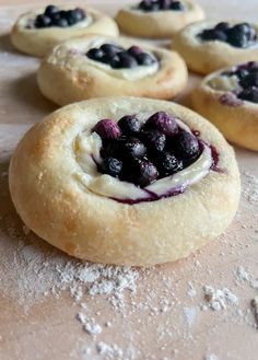 some blueberry pies are sitting on a table