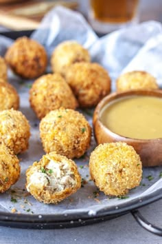 some fried food on a plate with dipping sauce