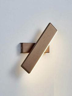 a wall mounted light on the side of a white wall with a dimmer in front of it