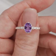 Introducing the exquisite "Juliet" Amethyst and White Topaz Ring – a timeless symbol of love and elegance. Crafted with passion and precision, this enchanting piece will captivate hearts and turn heads wherever it graces your hand. At the center of this ring lies a resplendent amethyst gemstone, deeply alluring with its regal purple hue. The amethyst, known for its association with tranquility and balance, embodies the spirit of royalty, making you feel like a true queen. Its mesmerizing violet tones dance gracefully in the light, commanding attention from all angles. Surrounding the amethyst are sparkling white topaz gemstones, meticulously set to accentuate the brilliance of the center stone. The white topaz, akin to little stars twinkling in the night sky, complements the amethyst's all Elegant Amethyst Ring With Gemstone Accents For Promise, Elegant Amethyst Crystal Ring With Center Stone, Elegant Amethyst Crystal Ring With Gemstone Accents, Elegant Purple Birthstone Ring With Gemstone Accents, Elegant Amethyst Diamond Ring With Gemstone Accents, Elegant Amethyst Ring With Gemstone Accents For Anniversary, Fine Jewelry Amethyst Ring With Accent Stones, Elegant Amethyst Crystal Ring With Accent Stones, Exquisite Amethyst Jewelry With Center Stone