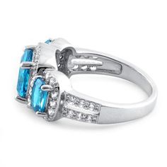 Top of ring height: 10.7mm

Top of ring width: 20mm

Band width: 4.7mm

Shank width: 2.4mm



Stone material: blue & clear cubic zirconia

Center stone size: 8mm

Stone shape: cushion cut (center) & round

Center stone carat weight: 2 ct.

Total number of CZ stones: 45

Stone setting: prong setting



Metal: 925 sterling silver

Plating: rhodium plated

Finish: high polish Stone Material, Stone Setting, Cz Ring, Cz Stone, Three Stone, Silver Blue, Stone Settings, Cushion Cut, Sterling Ring