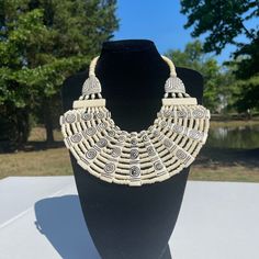 Check Our Lives Adjustable Cream Jewelry For Parties, Bohemian Cream Jewelry For Party, Cream Bohemian Jewelry For Party, Adjustable Cream Necklace For Party, Adjustable Traditional Cream Jewelry, Bohemian Cream Jewelry For Festivals, Adjustable White Metal Beaded Necklace, Adjustable Metal Bib Necklaces, Adjustable Cream Choker