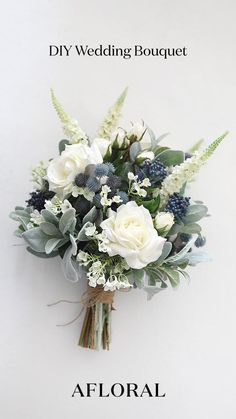 a white vase filled with flowers on top of a table