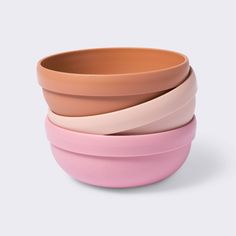 three different colored bowls stacked on top of each other