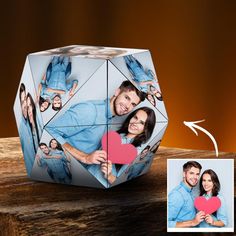 a couple holding a heart in front of a photo cube