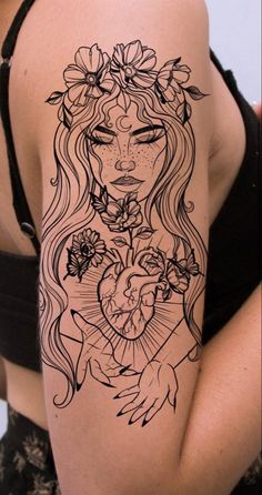 a woman's arm with a tattoo on it and flowers in her hair, holding a heart