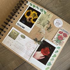 an open notebook with pictures and stickers on the cover, sitting on top of a wooden table