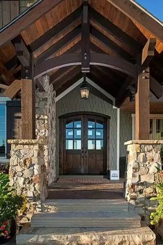 a house with stone steps leading to the front door and entry way that leads up to it