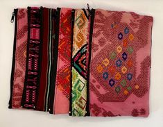 Set of 6 Fair Trade handwoven coin purses made by our artisan partners in Guatemala.   Each set includes six unique bags that combine nicely together. Exact colors may differ from what you see in photo.  Please message us for any special requests/bulk orders.  Details: Embroidered huipil design on front side and handwoven design on back. Zippered pouch with black lined interior.  Size: 8 in. x 5 in.  Care Instructions: Spot clean. Lay flat to dry.  If you spend over $250 in the store, you automatically receive 50% off your entire order.  Who We Are: We strive to create meaningful cultural connections through textiles and handicrafts by connecting skilled makers from our extensive network of partners across the Americas with shop owners, interior designers, and textile lovers across the wor Traditional Pink Rectangular Pouch, Traditional Handmade Pouch For Personal Use, Traditional Multicolor Zipper Pouch, Traditional Multicolor Pouch, Traditional Multicolor Pouch Coin Purse, Chic Purses, Zippered Pouch, Conscious Consumer, Unique Bags