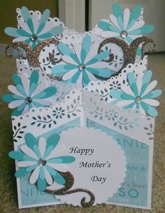 a mother's day card with blue flowers on the front and white paper in the back