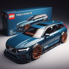 a blue car with orange rims is in front of a box that says lego technics