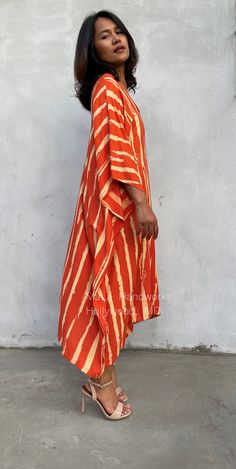 This kaftan complements all body types with its long, loose design and slits up both sides. The unique pattern is created by using a discharge dye process to remove color. I use a high quality rayon voile fabric that both flows and drapes around you. The eco printed kaftan can be worn in many stylish ways to make you look your best. DETAIL * All measurements are flat * Bust/ Waist/ Hips 34 in (Circumference 68 in.) * Arms 11 in. (Circumference 22 in.) * Length 42 in. * V-Neck * Side slits * No p Traditional Summer Sarong For Vacation, Traditional Summer Vacation Sarong, Orange Kimono For Vacation With Kimono Sleeves, Orange V-neck Kimono For The Beach, Traditional Orange Kimono For Summer, Traditional Orange Summer Kimono, Summer Beach Kimono With Ikat Print, Traditional Summer Kimono For Vacation, Long Kaftan For Poolside And Beachwear