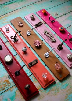 several different colored door knobs on wooden boards