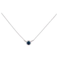 This simple sapphire and diamond necklace can go perfectly with a neck stack or on its own because of its delicate design. The contrast of the white diamond with the deep blue sapphire would catch anyone's eye. The details for this beautiful necklace are listed below: Metal Quality: 14K White Gold Pendant Style: Sapphire Diamond Halo Diamond Number: 22 Diamond Shape: Round Brilliant Diamond Total Weight: .13ct Diamond Clarity: VS2 (Excellent, Eye Clean) Diamond Color: G (Excellent, Near Colorless) Gemstone: Sapphire Gemstone Number: 1 Gemstone Shape: Round Gemstone Total Weight: .80ct Gemstone Color: Dark Blue Measurements of Pendant: 7.83mm Chain Type: Small Cable Chain Length: 18in Clasp: Lobster Chain Diameter: 1.25 Total Carat Weight: .96ct Elegant Blue Necklace With Single Cut Diamonds, Sapphire Necklace With Single Cut Diamonds, Sapphire Necklaces With Single Cut Diamonds, Round Sapphire Diamond-accented Necklace, Blue Diamond Necklace With Single Cut Diamonds, Round Sapphire Necklace With Diamond Accents, Round Sapphire Diamond Necklace With Diamond Accents, Round Sapphire Diamond Necklace With Accents, Formal Sapphire Necklace With Single Cut Diamonds