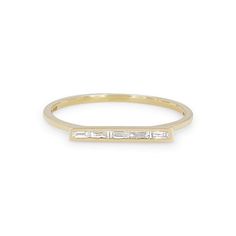 a yellow gold ring with three baguettes on the side, set in white diamonds