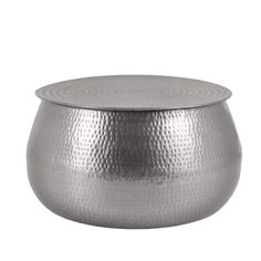 a large metal pot sitting on top of a table