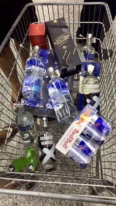 a shopping cart filled with bottled water and liquor