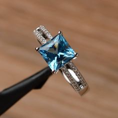 It is a Swiss blue topaz ring. The main stone is 7mm*7mm square cut, weight about 2.31carats. The basic metal is sterling silver and plated with rhodium. To change the metal to a solid gold (white/rose) or platinum is also available, please ask for a quotation if you want. You can also go to my shop Home for more elegant rings: https://www.etsy.com/shop/godjewelry?ref=hdr_shop_menu More rings: https://www.etsy.com/shop/godjewelry?ref=l2-shop-header-avatar Customization is always welcome and plea Blue Topaz Promise Ring, Blue Topaz Ring Sterling Silver, Topaz Wedding Ring, Elegant Rings, Pink Morganite Engagement Ring, Swiss Blue Topaz Ring, November Birthstone Ring, Topaz Birthstone, Blue Engagement Ring