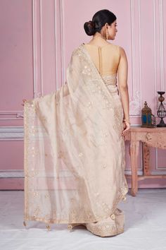 Flaunt your elegant style on festive occasions in this stunning beige embroidered tissue silk saree. It comes with a matching blouse piece. Disclaimer: The shown stitched blouse on the model is for display purpose only. The saree comes with a matching blouse piece and finished with fall and piko. Pure Tissue Silk Saree, Tussar Silk Sarees, Tissue Silk Saree, Indian Clothing Store, Tissue Saree, Latest Designer Sarees, Fashion Journals, Tussar Silk Saree, Indian Clothing