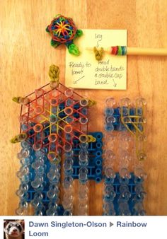 a wooden table topped with lots of plastic beads and magnets on top of it