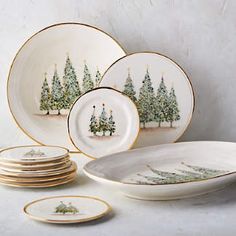 a set of christmas plates with trees on them